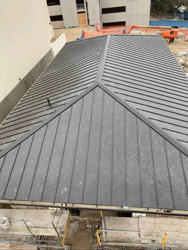 Commercial metal roof construction with crane equipment in Urbana